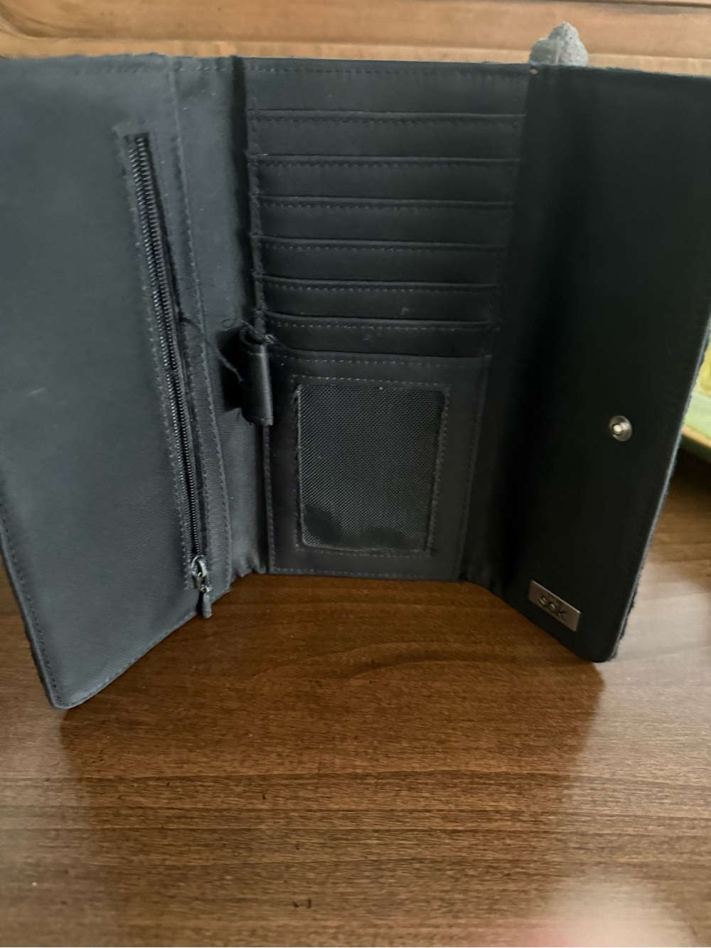 The Sak Black Trifold Wallet with Card Slots and Zipper Pocket